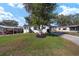 Charming home with a well-kept lawn, mature trees, and convenient carport at 1623 W Schwartz Blvd, The Villages, FL 32159