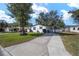 Inviting single-story home with a covered parking area and well-manicured landscaping at 1623 W Schwartz Blvd, The Villages, FL 32159