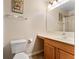 Bathroom with a single sink vanity and shower with curtain, offering essential facilities in a compact space at 16456 Meredrew Ln, Clermont, FL 34711