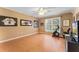 Bedroom featuring wood floor, a large window, and sports memorabilia hung around the room at 16456 Meredrew Ln, Clermont, FL 34711