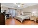 Bright bedroom with a ceiling fan, desk, and neutral-toned walls, creating a calming and functional space at 16456 Meredrew Ln, Clermont, FL 34711