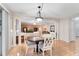 Dining area showcasing tile floors, decorative columns, chandelier, and open access to living spaces at 16456 Meredrew Ln, Clermont, FL 34711