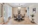 A well-lit dining room features a round table, four chairs, and elegant decor throughout the space at 16456 Meredrew Ln, Clermont, FL 34711