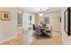 Dining room with a round table, four chairs, and a chandelier creating an inviting ambiance at 16456 Meredrew Ln, Clermont, FL 34711