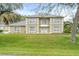 Inviting two-story home featuring well-manicured lawn, classic architecture, and welcoming front entrance at 16456 Meredrew Ln, Clermont, FL 34711