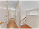 Hallway with archways leading to other rooms and stairs to another floor, providing open and airy transition spaces at 16456 Meredrew Ln, Clermont, FL 34711