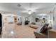 Spacious living room featuring tile flooring, neutral decor, ample lighting, and open layout at 16456 Meredrew Ln, Clermont, FL 34711