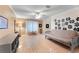 Spacious living room featuring tile floors, ceiling fan, and a comfortable futon sofa at 16456 Meredrew Ln, Clermont, FL 34711