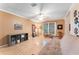 A large, bright living room with tile floors and a ceiling fan is the focal point of the house at 16456 Meredrew Ln, Clermont, FL 34711