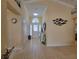 Inviting foyer with tile flooring, high ceilings, and a decorative mirror on the wall at 1670 Kensington Pl, The Villages, FL 32162