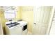 Bright laundry room with a washer, dryer, and hanging rack at 1670 Kensington Pl, The Villages, FL 32162