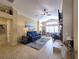 Comfortable living room featuring tile flooring, a ceiling fan, and a cozy seating area at 1670 Kensington Pl, The Villages, FL 32162