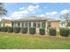 Well-maintained backyard with solar panels, a screened patio, and manicured landscaping at 1732 Madero Dr, Lady Lake, FL 32159