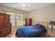 Cozy bedroom with neutral walls, a ceiling fan, and a large window providing natural light at 1732 Madero Dr, The Villages, FL 32159