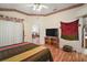 Comfortable bedroom with wood laminate floors and ceiling fan; view of the Primary bathroom at 1732 Madero Dr, Lady Lake, FL 32159