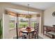 Bright breakfast nook with a bay window, stained glass pendant light, and comfortable seating at 1732 Madero Dr, Lady Lake, FL 32159