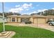 Charming one-story home with a two-car garage, decorative front door, and stone accents at 1732 Madero Dr, Lady Lake, FL 32159