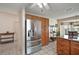 Kitchen featuring stainless steel refrigerator, oak cabinets, and tile floors near an eat-in area at 1732 Madero Dr, The Villages, FL 32159