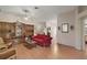 Spacious living room featuring hardwood floors, built-in shelving, and a cozy seating area at 1732 Madero Dr, The Villages, FL 32159