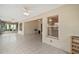 Large tiled patio area with multiple ceiling fans, windows, and access to a screened-in porch at 1732 Madero Dr, The Villages, FL 32159