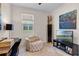 Bonus room with decorative chair, television, window, and natural light at 17369 Blazing Star Cir, Clermont, FL 34714