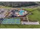 Aerial view of resort-style community pool, pickle ball, and bocce ball courts at 17369 Blazing Star Cir, Clermont, FL 34714