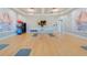 Bright exercise room featuring yoga mats, fitness balls, weights, and wall-mounted TV at 17369 Blazing Star Cir, Clermont, FL 34714