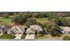 Aerial view of a residential area showcasing homes with lush landscaping and mature trees at 21051 Royal St Georges Ln, Leesburg, FL 34748