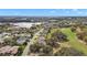 Aerial view of home and neighborhood near lake and golf course at 21051 Royal St Georges Ln, Leesburg, FL 34748