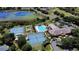 Aerial view of community amenities with pool, tennis courts, and clubhouse at 21051 Royal St Georges Ln, Leesburg, FL 34748