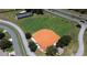 Aerial view of a well-maintained baseball field and pickleball courts in the community at 21051 Royal St Georges Ln, Leesburg, FL 34748