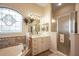 Bathroom boasts separate shower, soaking tub, and vanity with ample storage at 21051 Royal St Georges Ln, Leesburg, FL 34748