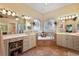 Bathroom featuring a soaking tub, double vanities, and decorative tile work at 21051 Royal St Georges Ln, Leesburg, FL 34748