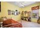 Second bedroom with ceiling fan, natural light, and decorative motorsport theme at 21051 Royal St Georges Ln, Leesburg, FL 34748