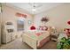 Cozy bedroom featuring carpet flooring, ceiling fan, and a charming window at 21051 Royal St Georges Ln, Leesburg, FL 34748