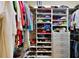 Organized walk-in closet with shelving for clothes, shoes and accessories at 21051 Royal St Georges Ln, Leesburg, FL 34748