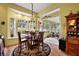 Dining room with large bay window, a decorative chandelier and access to Florida room at 21051 Royal St Georges Ln, Leesburg, FL 34748