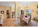 Formal dining room with chandelier, hardwood floors, and large windows providing ample natural light at 21051 Royal St Georges Ln, Leesburg, FL 34748