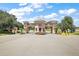 Gated community entrance features manicured landscaping and elegant architecture at 21051 Royal St Georges Ln, Leesburg, FL 34748