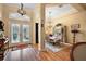 Elegant foyer featuring decorative glass doors, hardwood floors, and a view of the dining area at 21051 Royal St Georges Ln, Leesburg, FL 34748