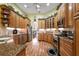 Well-equipped kitchen featuring granite counters, stainless steel appliances, and wood cabinetry at 21051 Royal St Georges Ln, Leesburg, FL 34748