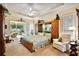 Serene main bedroom with king bed, sitting area, and sliding glass doors to the outdoor patio at 21051 Royal St Georges Ln, Leesburg, FL 34748