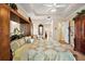 Spacious main bedroom featuring a tray ceiling, wooden wardrobe and an en-suite bathroom at 21051 Royal St Georges Ln, Leesburg, FL 34748