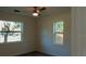 Cozy bedroom featuring two windows offering lots of natural light and wood flooring at 2210 Grant Ave, Eustis, FL 32726