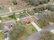 Aerial view of home featuring a pool, fenced yard, and well-maintained landscaping at 2214 Lake Pointe Cir, Leesburg, FL 34748