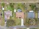 Overhead shot of a home showcasing its backyard pool, green lawn, and clean roof at 2214 Lake Pointe Cir, Leesburg, FL 34748