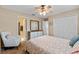 Comfortable bedroom with a ceiling fan, dresser, closet, and serene ambiance at 2214 Lake Pointe Cir, Leesburg, FL 34748