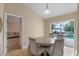 Cozy dining room with sliding doors to a screened lanai and pool at 2214 Lake Pointe Cir, Leesburg, FL 34748