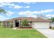 Charming single-story home with a well-manicured lawn and a two-car garage at 2214 Lake Pointe Cir, Leesburg, FL 34748