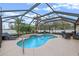 Inviting screened-in pool with waterfall feature, surrounded by ample seating at 2214 Lake Pointe Cir, Leesburg, FL 34748